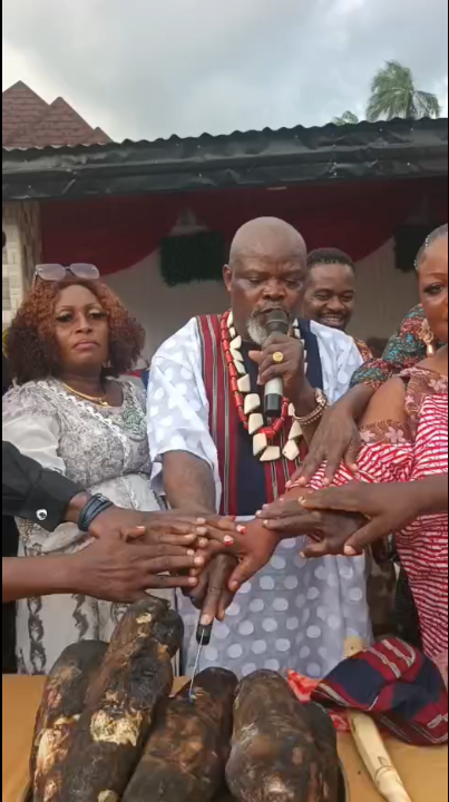 Chief Ezeafulukwe cuts the New Yam.